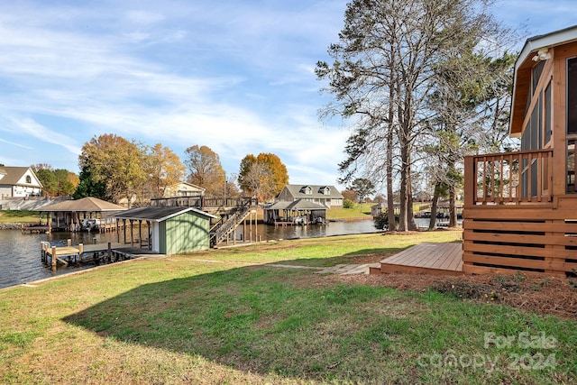 view of yard featuring a dock and a deck with water view