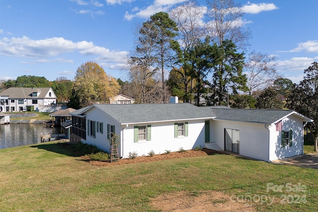 exterior space featuring a water view and a front lawn