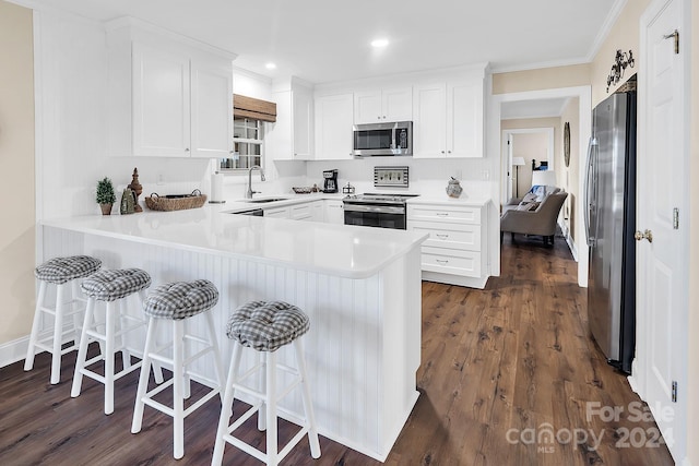 kitchen featuring white cabinets, stainless steel appliances, and dark hardwood / wood-style floors