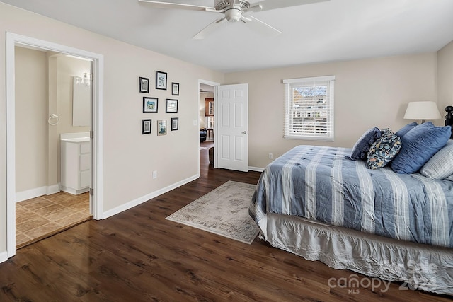 bedroom with ensuite bathroom, ceiling fan, and dark wood-type flooring