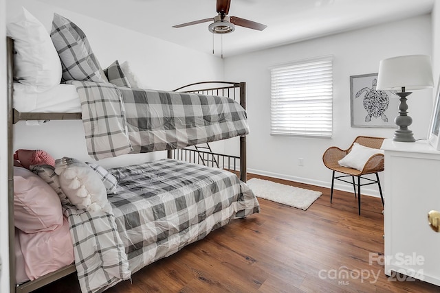 bedroom with ceiling fan and dark wood-type flooring