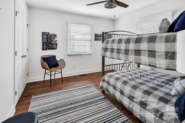 bedroom with ceiling fan and dark wood-type flooring