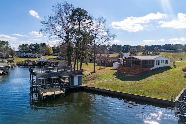 dock area with a yard and a water view