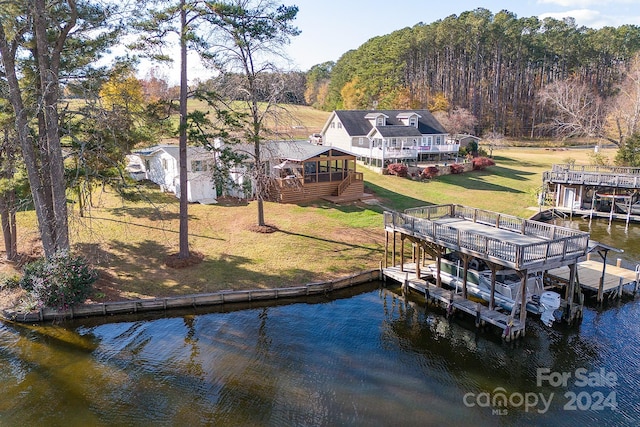 view of dock featuring a lawn and a deck with water view