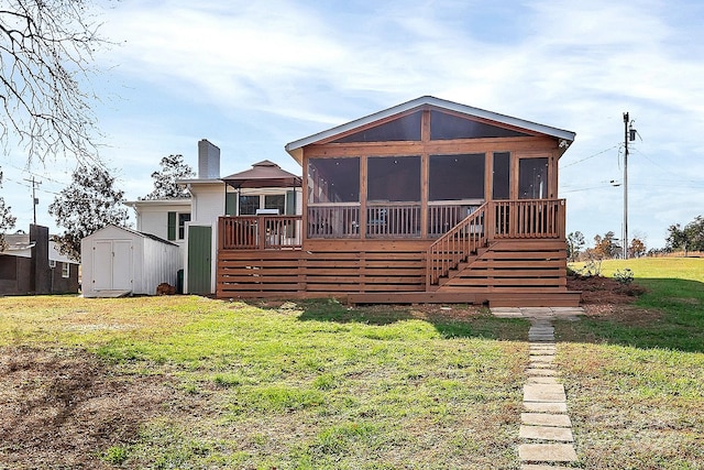 back of house with a storage unit, a yard, and a wooden deck