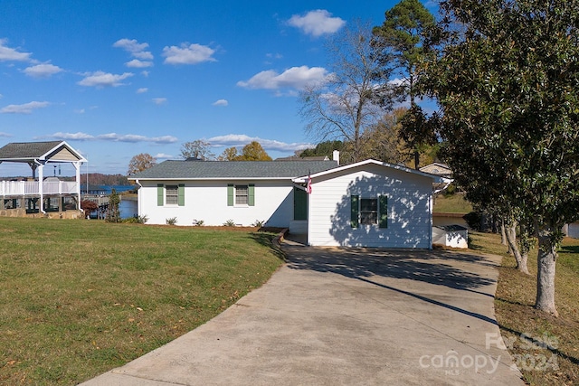 view of front of house with a water view and a front lawn