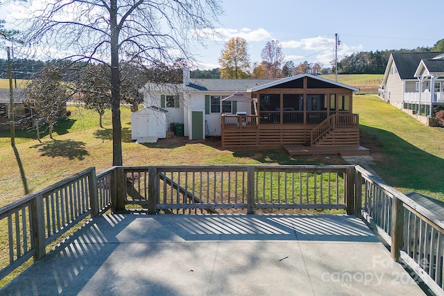 deck featuring a yard and a storage shed