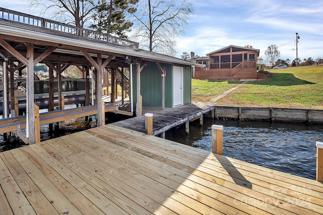 dock area featuring a lawn and a water view