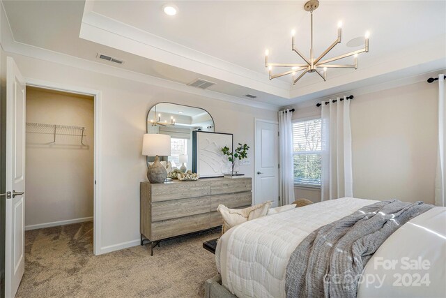 4003 Bourne Ct Lot 41, Charlotte, NC 28262 - bedroom with a chandelier, a spacious closet, a raised ceiling, light colored carpet, and crown molding