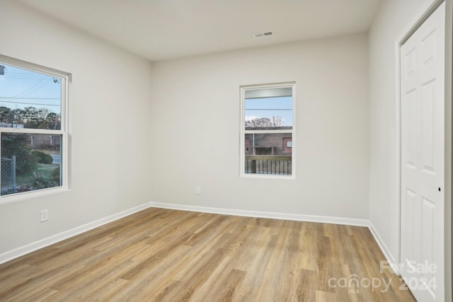 unfurnished bedroom featuring light hardwood / wood-style floors and a closet