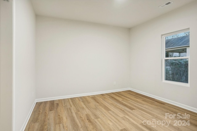 empty room with light hardwood / wood-style floors and a wealth of natural light