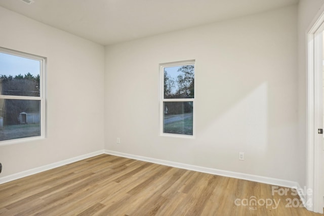 spare room featuring light hardwood / wood-style floors