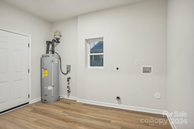 laundry area featuring hookup for a washing machine, water heater, light hardwood / wood-style flooring, and hookup for an electric dryer
