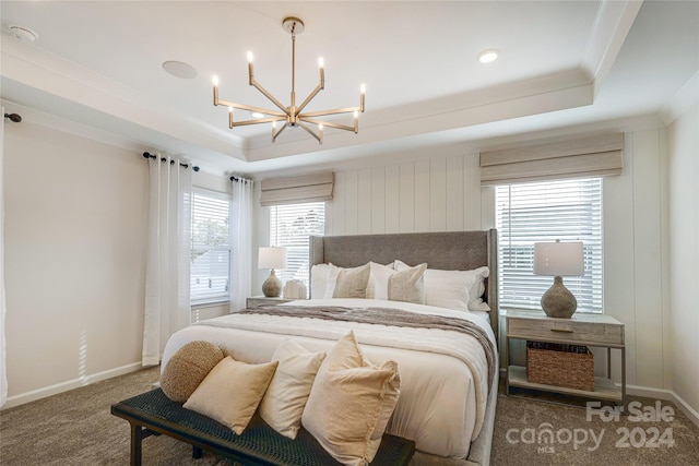 bedroom featuring carpet, a chandelier, crown molding, and a tray ceiling