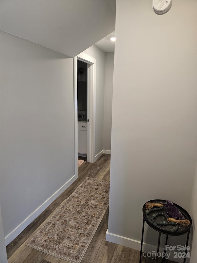 hall with dark hardwood / wood-style flooring