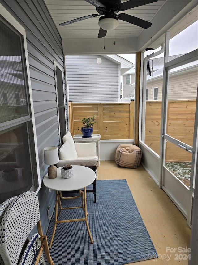 sunroom featuring ceiling fan