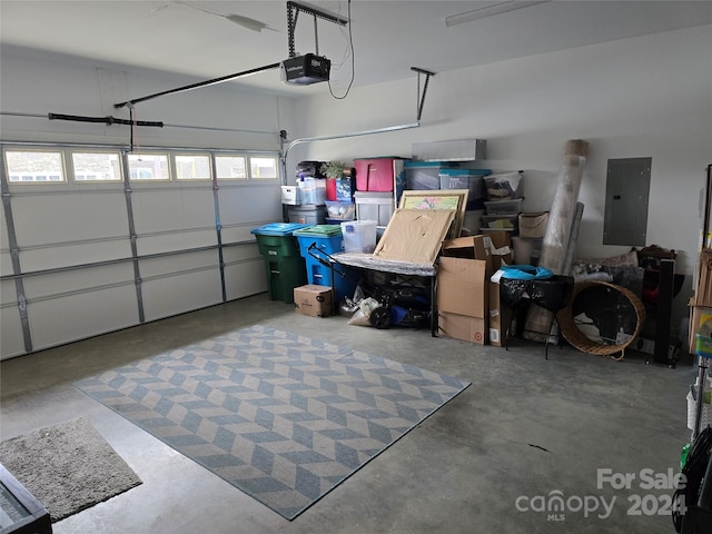 garage with electric panel and a garage door opener