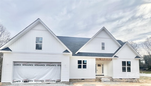 modern inspired farmhouse with a garage, crawl space, board and batten siding, and roof with shingles