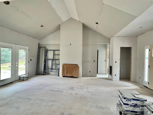 interior space featuring high vaulted ceiling and french doors