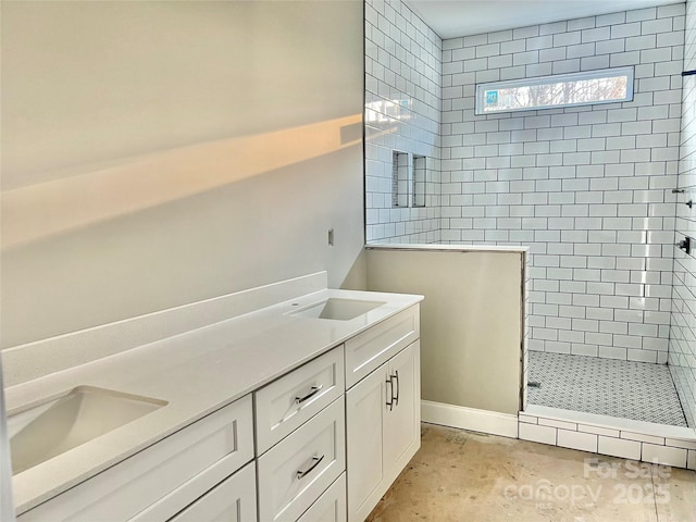 full bathroom with a shower stall, double vanity, and a sink