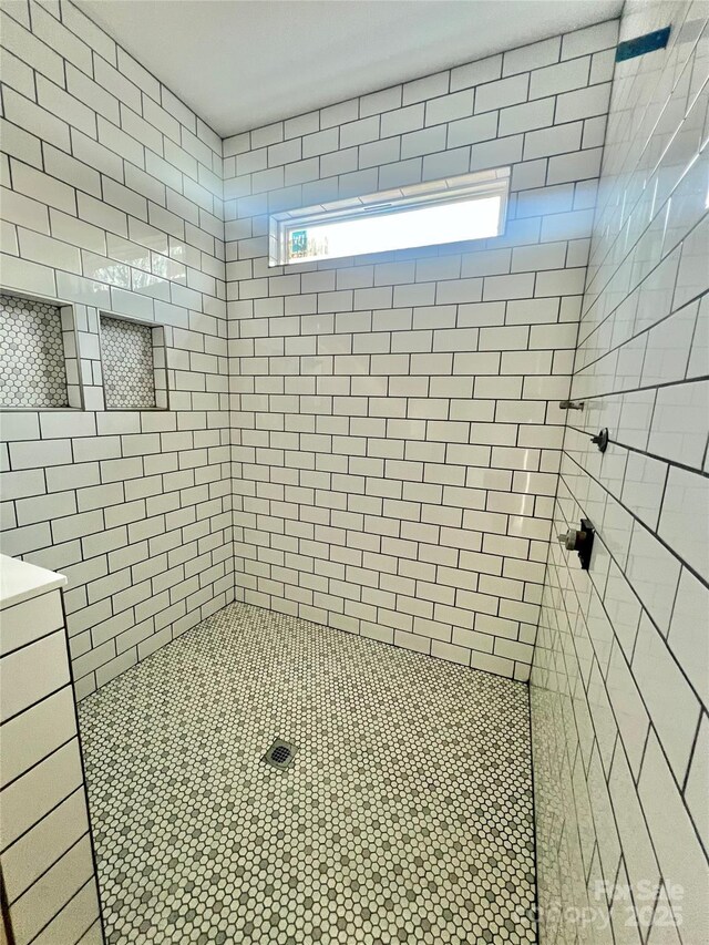 full bath featuring tiled shower