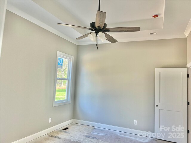 empty room with baseboards and a ceiling fan