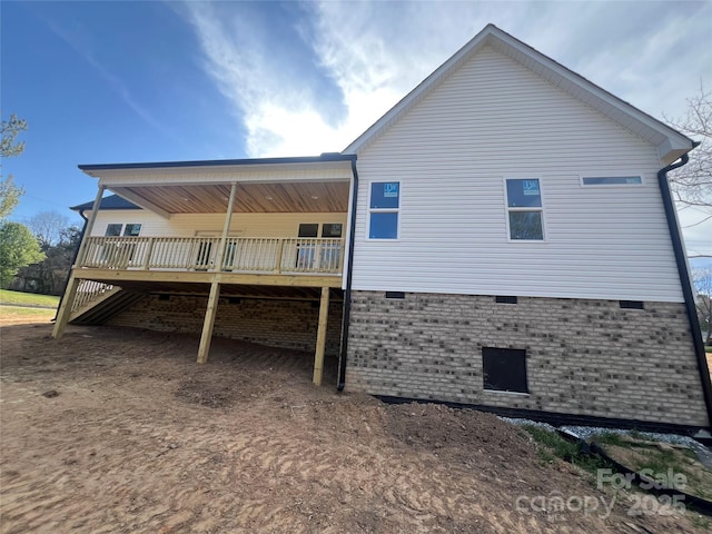 rear view of house with a wooden deck