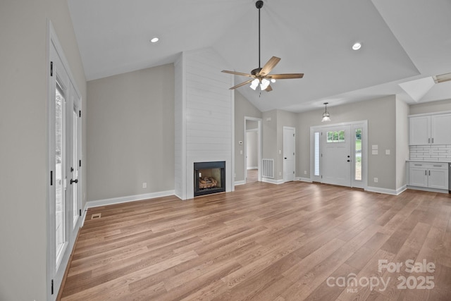 unfurnished living room featuring a fireplace, a ceiling fan, baseboards, and light wood-type flooring
