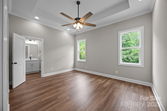 unfurnished bedroom with crown molding, visible vents, multiple windows, and dark wood-type flooring
