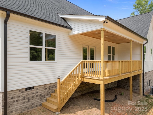 rear view of property with a shingled roof, french doors, and crawl space