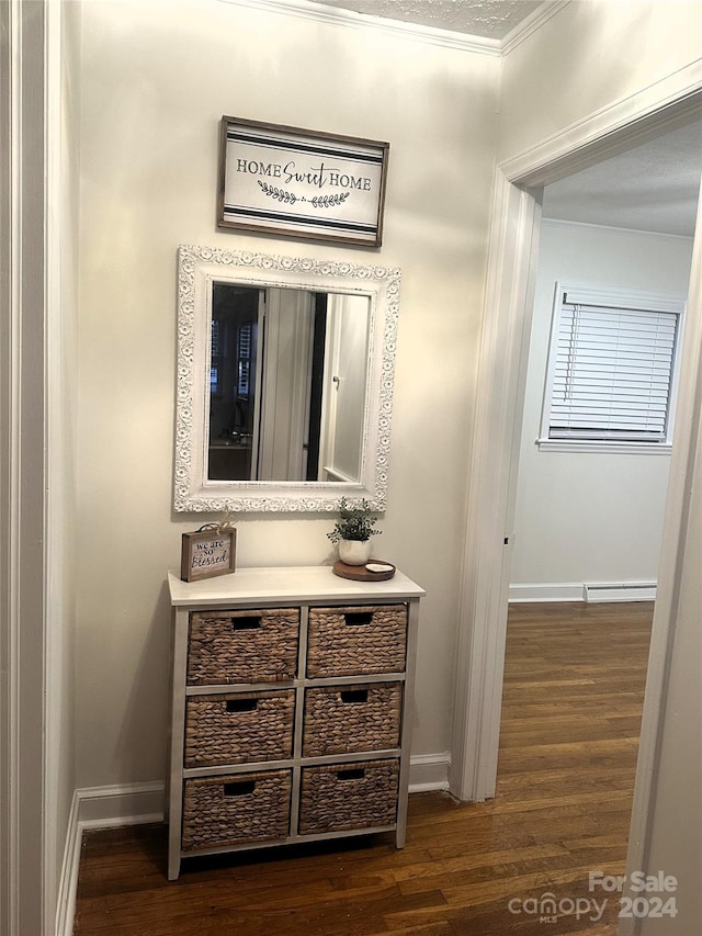 bathroom with hardwood / wood-style flooring, crown molding, and a textured ceiling