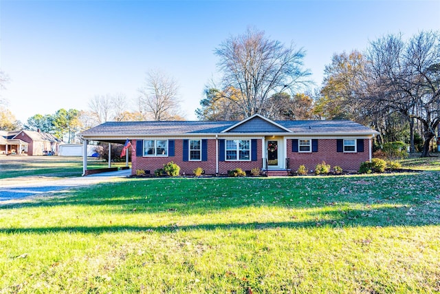 ranch-style house featuring a carport and a front lawn