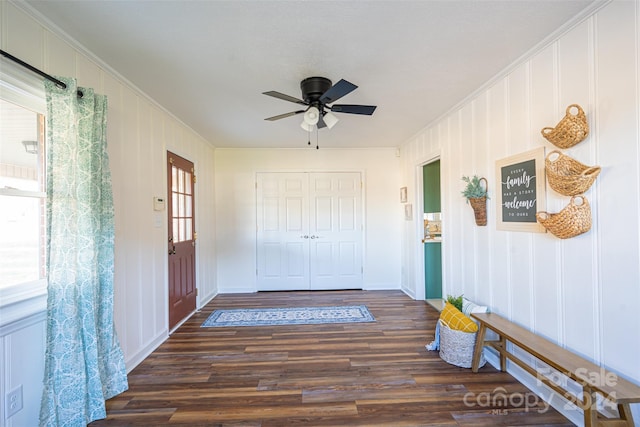 hallway with crown molding and dark wood-type flooring