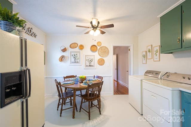 kitchen featuring light hardwood / wood-style flooring, ceiling fan, washing machine and dryer, white fridge with ice dispenser, and ornamental molding