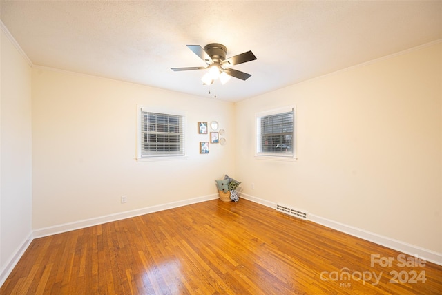 unfurnished room with crown molding, ceiling fan, and hardwood / wood-style flooring