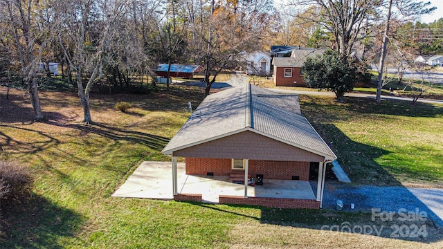 view of community with a yard and a patio