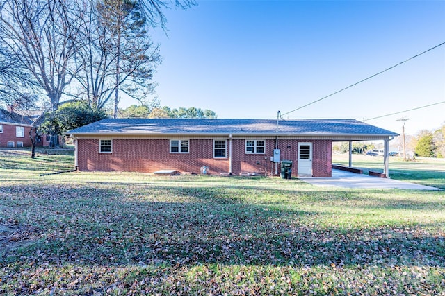 rear view of property with a lawn