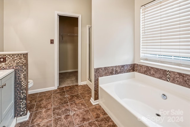 full bathroom with tile patterned flooring, vanity, independent shower and bath, and toilet