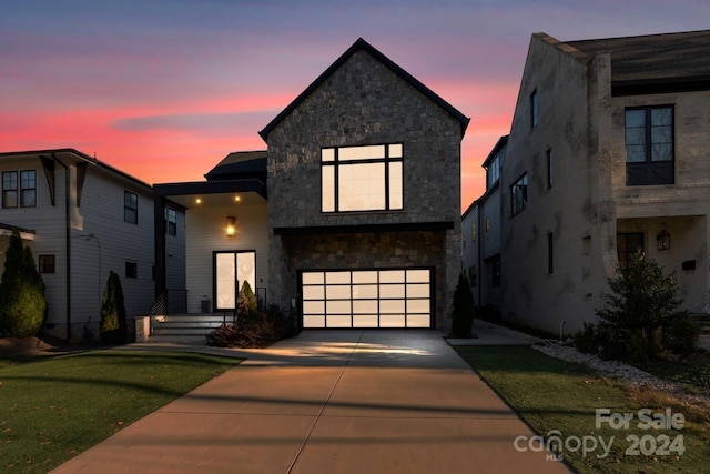 view of front facade featuring a yard and a garage