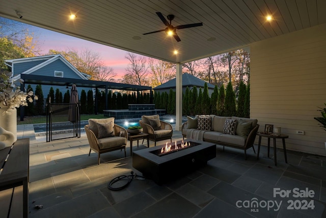 patio terrace at dusk featuring an outdoor living space with a fire pit and ceiling fan