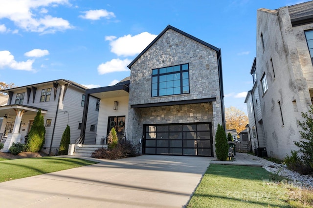 contemporary house with a front lawn, a garage, and central AC unit