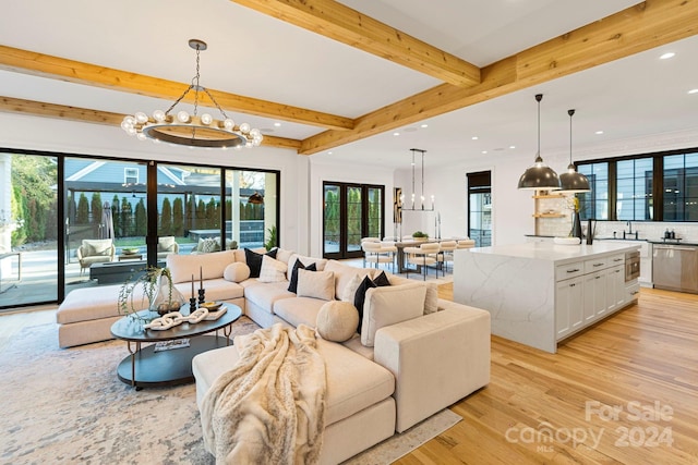 living room featuring beam ceiling, light hardwood / wood-style flooring, and a notable chandelier