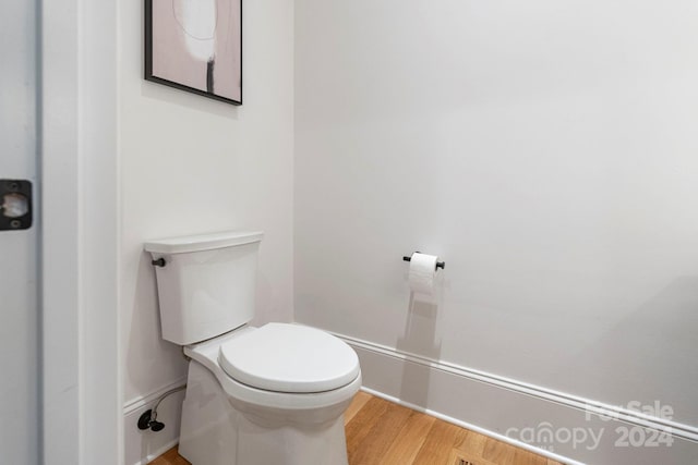 bathroom with hardwood / wood-style floors and toilet