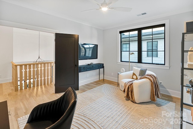 interior space featuring ceiling fan, hardwood / wood-style floors, and ornamental molding