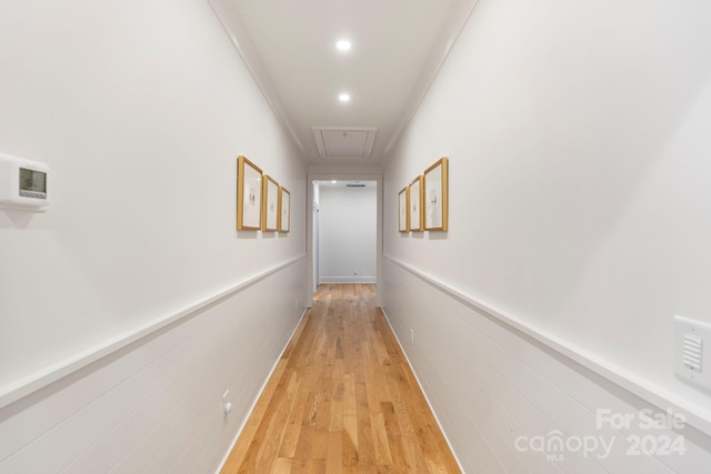 hall featuring light wood-type flooring and crown molding