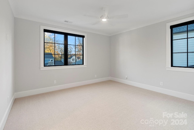 carpeted spare room featuring ceiling fan