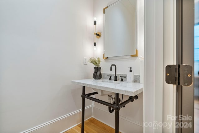 bathroom with hardwood / wood-style floors and sink