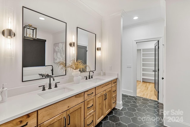 bathroom featuring hardwood / wood-style flooring, vanity, and ornamental molding