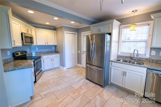 kitchen with appliances with stainless steel finishes, dark stone counters, ornamental molding, sink, and pendant lighting