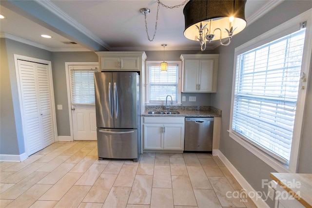 kitchen with white cabinets, stainless steel appliances, and a healthy amount of sunlight